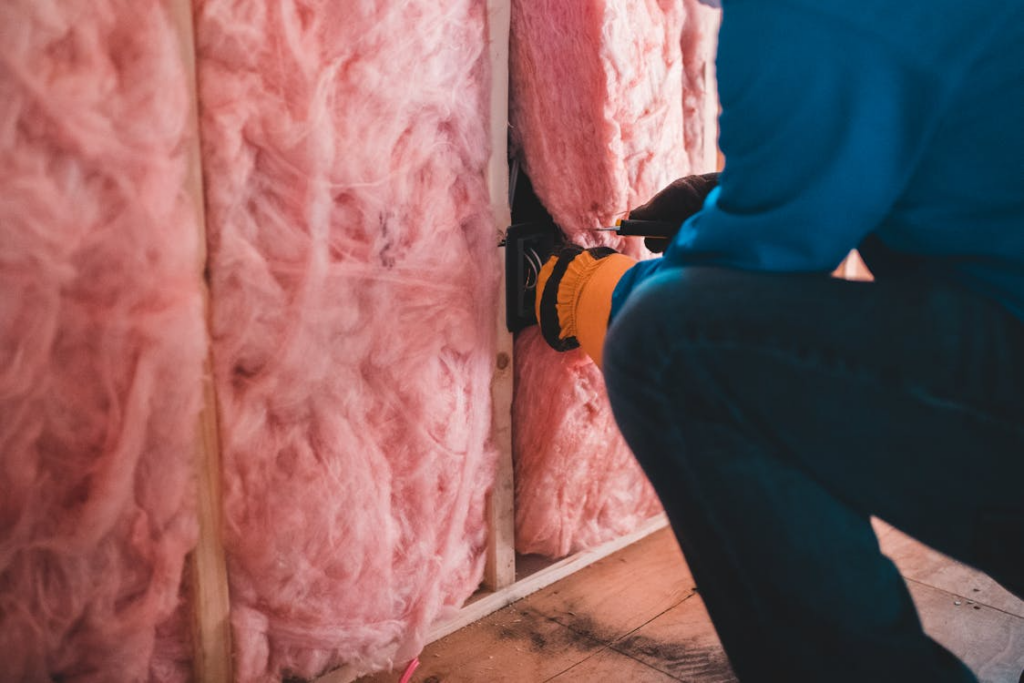 Installing insulation during professional soundproofing services for noise reduction