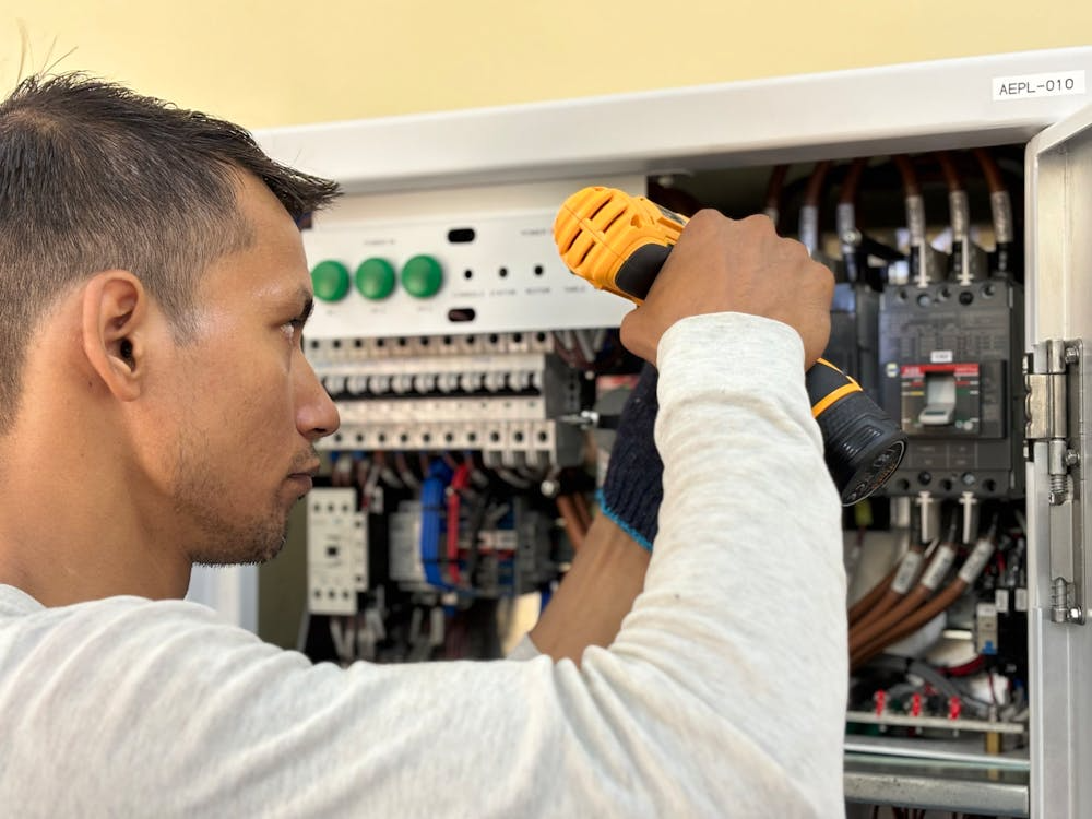 electrician installing surge protection device during whole home surge protection installation